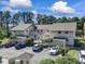 An inviting exterior view of the condo complex with lush landscaping, ample parking, and a charming stairwell to upper units at 3015 Old Bryan Dr. # 13-1, Myrtle Beach, SC 29577