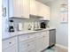 Well-lit kitchen featuring white cabinets, sleek appliances, and luxurious countertops offering a modern cooking space at 3015 Old Bryan Dr. # 13-1, Myrtle Beach, SC 29577