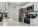 Modern kitchen showcasing quartz countertops, stainless steel appliances, and bright white cabinetry offering ample space at 3015 Old Bryan Dr. # 13-1, Myrtle Beach, SC 29577