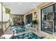 The covered patio includes rocking chair, storage shelving, and a view to the indoors through a sliding door at 3015 Old Bryan Dr. # 13-1, Myrtle Beach, SC 29577