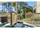 A cozy back patio features views of the private backyard and wooded landscape at 3015 Old Bryan Dr. # 13-1, Myrtle Beach, SC 29577