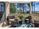 Enjoy relaxing on this cozy patio with outdoor seating and a beautiful view of the surrounding trees at 3015 Old Bryan Dr. # 13-1, Myrtle Beach, SC 29577