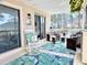 Inviting covered porch with seating, a ceiling fan, and serene view of the surrounding greenery at 3015 Old Bryan Dr. # 13-1, Myrtle Beach, SC 29577