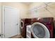 Laundry room with washer, dryer, and storage shelving at 109 Pheasant Run Dr., Murrells Inlet, SC 29576