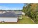 Aerial view of backyard featuring a covered patio and lush landscaping, surrounded by mature trees at 385 Sun Colony Blvd., Longs, SC 29568