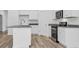 Bright kitchen features white cabinets, granite counters, stainless steel appliances, and a functional center island at 385 Sun Colony Blvd., Longs, SC 29568