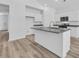 A spacious kitchen boasts a center island, granite countertops, and stainless steel appliances at 385 Sun Colony Blvd., Longs, SC 29568