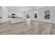 Open concept kitchen-living area with luxury vinyl plank flooring at 385 Sun Colony Blvd., Longs, SC 29568
