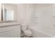 Bathroom with white vanity, matching toilet, and a shower-tub combo with built-in shelving at 230 Ashworth Dr., Tabor City, NC 28463
