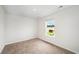 Bright bedroom featuring neutral carpet, white walls, and natural light from the window at 230 Ashworth Dr., Tabor City, NC 28463