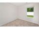 Bright bedroom featuring neutral carpet, white walls, and natural light from the window at 230 Ashworth Dr., Tabor City, NC 28463
