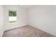 Bright bedroom featuring neutral carpet, white walls, and natural light from the window at 230 Ashworth Dr., Tabor City, NC 28463