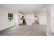 Bright living room with wood-look flooring and an open floor plan into the kitchen at 230 Ashworth Dr., Tabor City, NC 28463