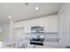 Kitchen showcasing stainless steel appliances, white cabinets, and neutral countertops at 244 Ashworth Dr., Tabor City, NC 28463