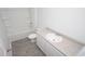 Clean bathroom with a shower-tub combo, gray-toned flooring, and modern fixtures at 358 Jeff Waters Circle, Longs, SC 29568