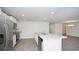 Modern kitchen features stainless appliances, gray countertops, island with a sink, and recessed lighting at 358 Jeff Waters Circle, Longs, SC 29568