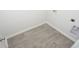 Laundry room boasts plank flooring, utility connections, and neutral paint at 358 Jeff Waters Circle, Longs, SC 29568