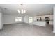 Open floor plan features plank floors, kitchen with island and stainless appliances, and dining area at 358 Jeff Waters Circle, Longs, SC 29568