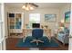 Comfortable home office with hardwood flooring, a large desk, and a cozy blue chair at 340 Walden Lake Rd., Conway, SC 29526