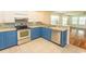 A kitchen boasting stainless steel appliances and blue cabinets at 340 Walden Lake Rd., Conway, SC 29526