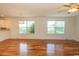 Bright living room features hardwood floors, lots of natural light, and a ceiling fan at 340 Walden Lake Rd., Conway, SC 29526