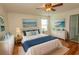 Comfortable bedroom features beach-themed artwork, a ceiling fan and hardwood floors at 340 Walden Lake Rd., Conway, SC 29526