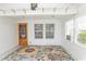 Inviting sunroom featuring white paneled walls, large windows, and a vibrant rug, perfect for relaxing at 340 Walden Lake Rd., Conway, SC 29526