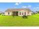 Wide shot of the back exterior of the home, with a screened porch, and open lawn at 719 American Beech St., Loris, SC 29569