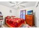 Bedroom with ceiling fan, TV, and brightly colored bedding at 719 American Beech St., Loris, SC 29569