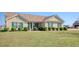 Charming single-story home with green shutters, a manicured lawn, and tasteful landscaping at 719 American Beech St., Loris, SC 29569