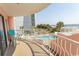 Balcony view of pool, ocean, and palm trees for a relaxing vacation experience at 202 70Th Ave. N # 104, Myrtle Beach, SC 29572