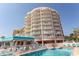 Exterior view of a multi-story resort building with balconies, overlooking the pool at 202 70Th Ave. N # 104, Myrtle Beach, SC 29572