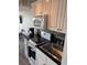 Well-equipped kitchen with white cabinets, granite counters, and stainless steel appliances at 202 70Th Ave. N # 104, Myrtle Beach, SC 29572