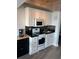 Cozy kitchen features white cabinets, black countertops, and stainless steel appliances at 202 70Th Ave. N # 104, Myrtle Beach, SC 29572