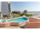 Relaxing pool area with lounge chairs and ocean views surrounded by palm trees at 202 70Th Ave. N # 104, Myrtle Beach, SC 29572