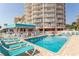Resort swimming pool with ample lounge seating, and a multi-story building in the background at 202 70Th Ave. N # 104, Myrtle Beach, SC 29572