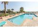 Large outdoor swimming pool surrounded by lounge chairs and lush landscaping near the ocean at 202 70Th Ave. N # 104, Myrtle Beach, SC 29572
