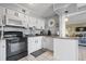 Kitchen with white cabinets, granite counters, and a view into the living area at 5905 South Kings Hwy. # A450, Myrtle Beach, SC 29575