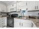 Modern kitchen with white cabinets, granite countertops, and stainless steel sink at 5905 South Kings Hwy. # A450, Myrtle Beach, SC 29575