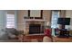 A stone fireplace with a mantel and a mirror above anchors the cozy living room at 78 Joys Pl., Andrews, SC 29510