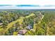 Aerial view of a home with a pool, surrounded by trees and a golf course at 1296 Foxtail Dr., Longs, SC 29568