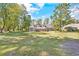 Spacious backyard with green lawn and a covered patio at 1296 Foxtail Dr., Longs, SC 29568