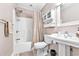 Well-lit bathroom featuring a shower with curtain, pedestal sink, and white toilet at 1296 Foxtail Dr., Longs, SC 29568