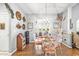 Bright dining room features a glass table, decorative chandelier, and charming decor throughout at 1296 Foxtail Dr., Longs, SC 29568
