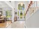 Bright foyer featuring a chandelier, a large arched window, and a staircase at 1296 Foxtail Dr., Longs, SC 29568