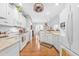 Bright kitchen with white cabinetry, stainless steel appliances, and hardwood floors at 1296 Foxtail Dr., Longs, SC 29568