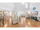 Spacious living room featuring hardwood floors, neutral walls, and a decorative rug at 1296 Foxtail Dr., Longs, SC 29568