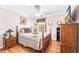 Inviting main bedroom featuring a bed with a patchwork quilt, dark wooden furniture, and natural light at 1296 Foxtail Dr., Longs, SC 29568