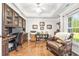 Home office featuring built-in cabinets, desk, hardwood floors, and a comfortable chair at 1296 Foxtail Dr., Longs, SC 29568