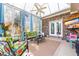 Charming sunroom featuring a brick accent wall, tropical seating, and natural light at 1296 Foxtail Dr., Longs, SC 29568
